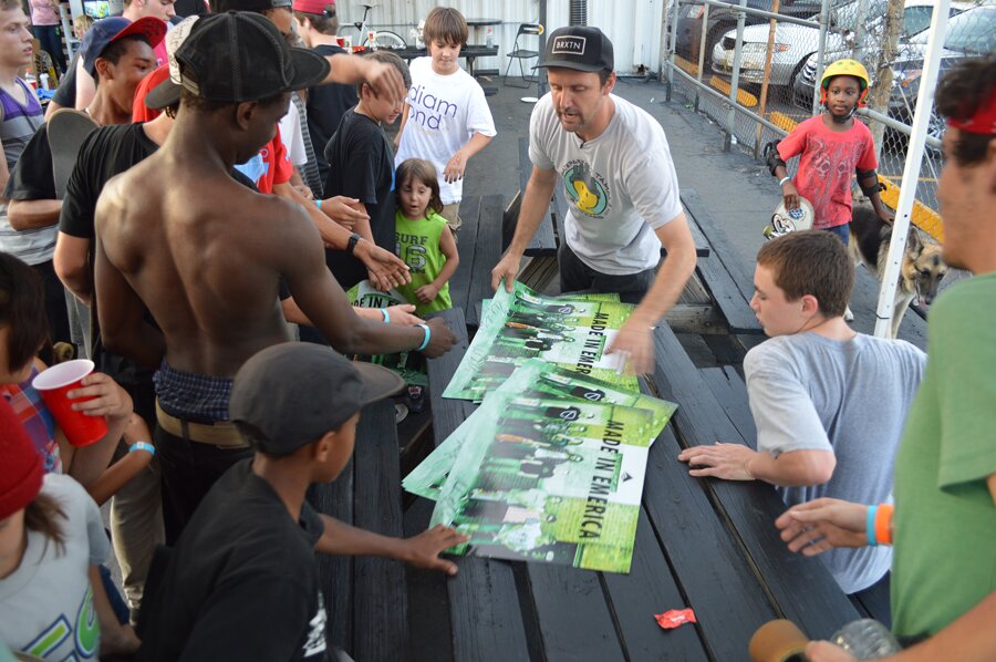 Schaefer handing out posters to the kids