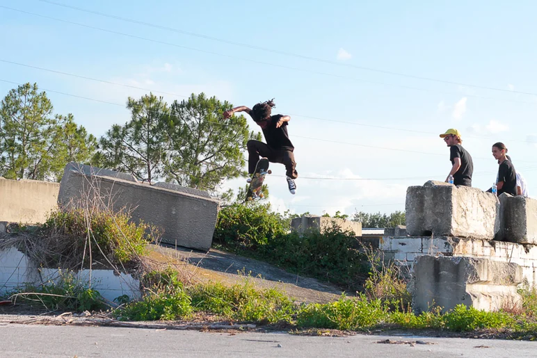 <!--conshaines-->

Derick has got a pretty mean No Comply as demonstrated here over the bush into the bank.