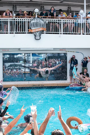 The winner of the belly flop contest giving one last flop for the crowd.

<!--floggingmollycruise23-->