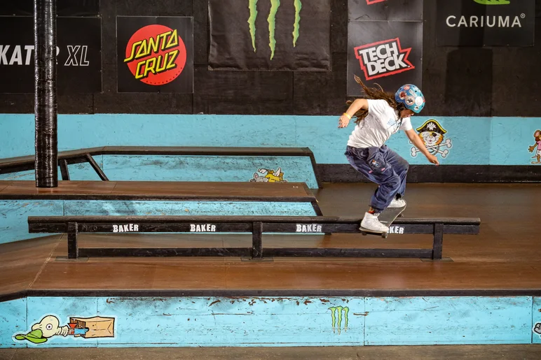 Rebecca Hubbard with a back board on the baker rail


<!--schoolsoutjam24-->