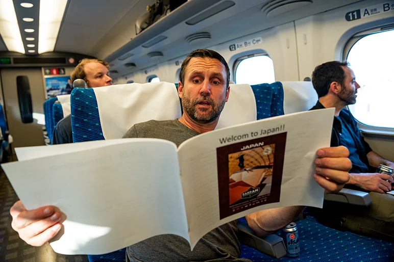 <!--daja18-day1-->

He also takes a look at the Japan Damn Am handbook that our hosts so graciously put together for us.
