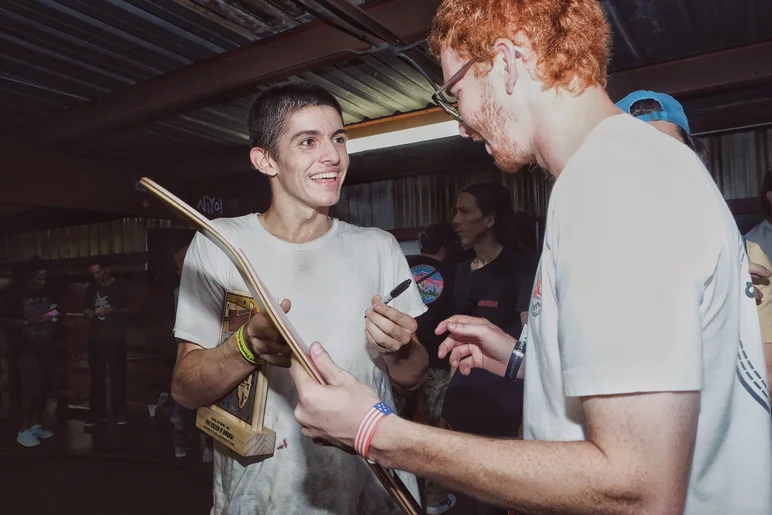 <!--am19bowljam-->

Jake signs a fan's board.