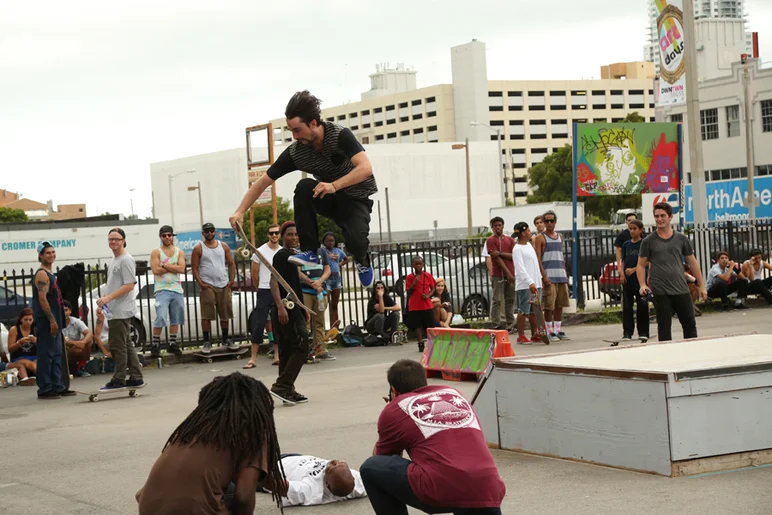 <!-- MIAsummer2013 -->

Chris Blake jumping over one of the locals while local photographer Matt Roy snaps a photo.