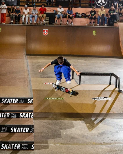 Matheus Reis with a Heelflip off the deck

<!--harvestjam2023-->