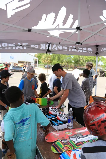 <!--gsd14-->
Kids packed out the SPoT tent to get a chance to get free products from decks to shoes.
