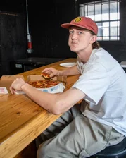 Peter enjoying pizza