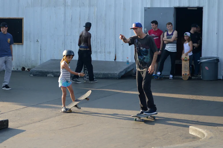Andrew teaching Stella how to come off a curb.<!-- Andrew Reynolds at SPoT for the Lakeland Skatepark Grand Opening -->