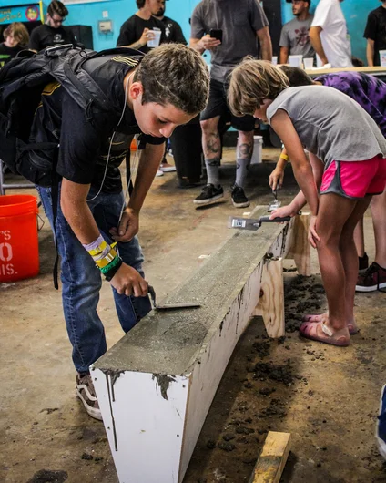 <!--consproject-->

Once the mold is full, the kids smoothed out the edges with a trowel.

