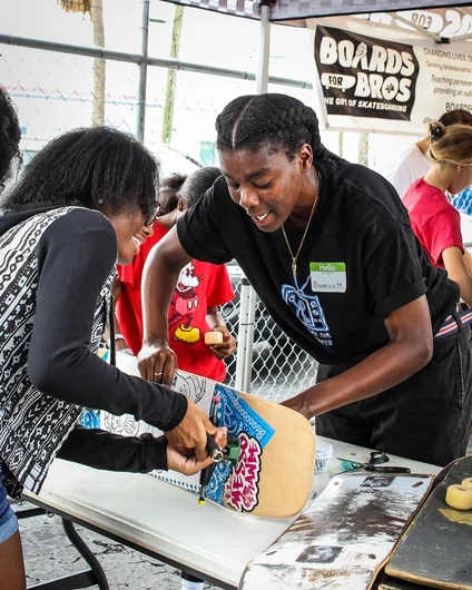 <!--girlsclinic19-->

Here she is helping a group of young ladies assemble a new board.
