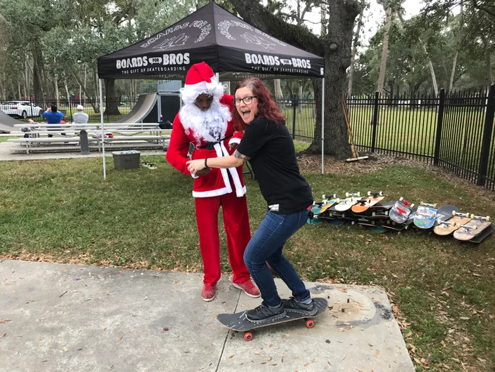 <!--b4bdesoto-->

Seeing all these kids learning how to skate made some adults want to try it too. That's my wife Catherine (another Boards for Bros volunteer) getting some help from Santa...