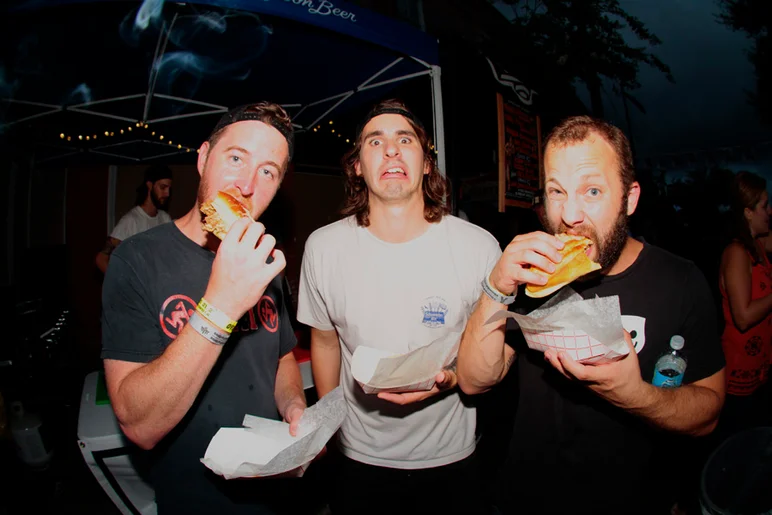 <!--bricks5year-->
Did I mention there was some delicious food cooking outside? These guys had some. The guy in the middle probably ate his too quick.