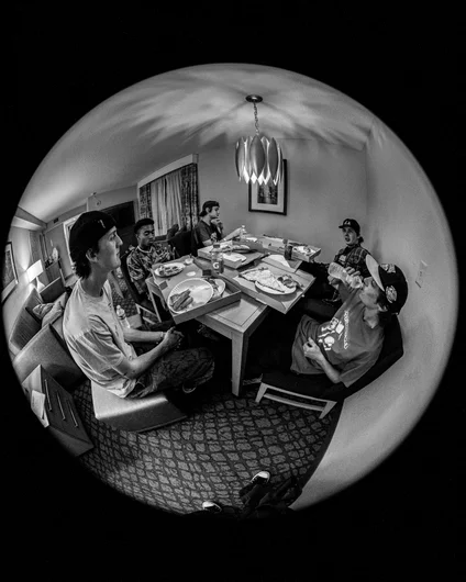 Bonus photo of our pizza party in the hotel room. Whenever the fisheye isn't cropped I get M.C. Escher 'Self Portrait' vibes. Black and white as a nod to that.

<!--floridagrovesfest23-->
