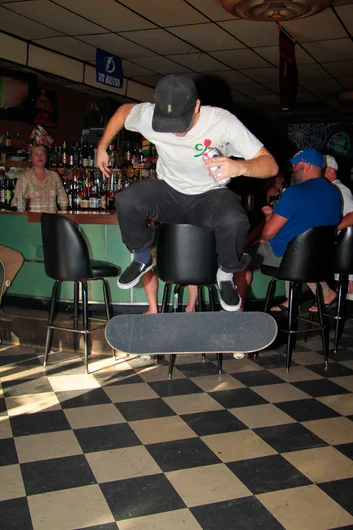 <!--ssc15-->

Nick Zizzo Kickflipping in the bar with brew in hand.