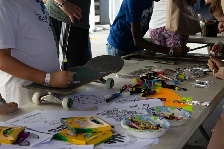 <!--mattwoodsday18-->

We had a craft table set up so the kids could draw on their griptape and helmets.