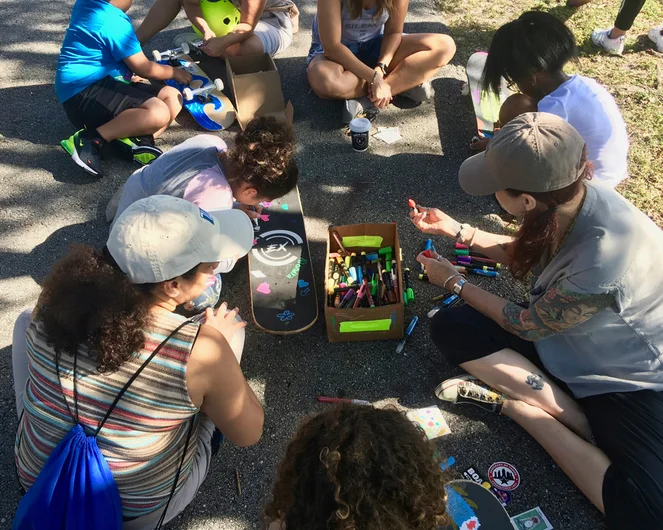 <!--b4bbroward-->
After the kids grab their boards, they hit up the paint pen station to customize their grip. We do this because it is fun, encourages gives them ownership of their board and it avoids “he/she took my board” conflicts during the session!