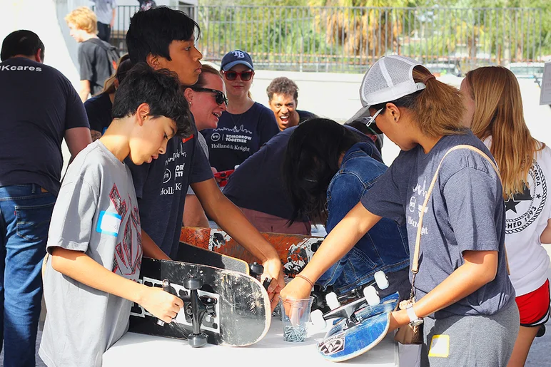 <!--b4bbuildday17-->
The hardware team (seen here) attached the donated trucks to used decks before sending them off to get griptape.