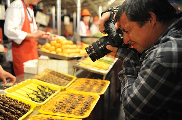 Chris Ortiz in China - tarantulas on a stick