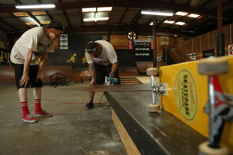 <!-- 2013coursedemo -->
Knowledge is being passed down here from veteran to novice. Chris Reitz looks on and learns how to properly cut through skatelite.