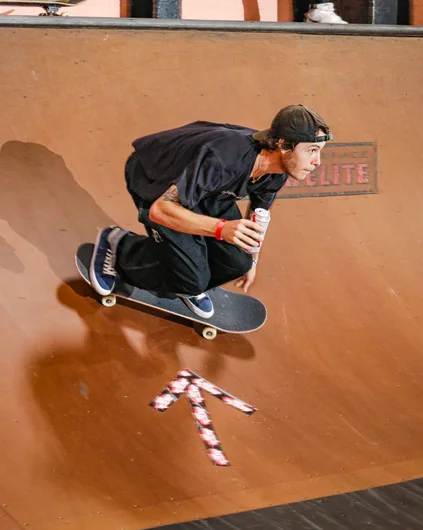 Mikey Premet of Westside Skateshop grabs a cold one during a warm up lap for the Death Race

<!--clashofthecrews23-->