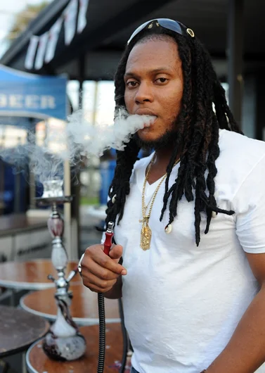 <!-- tampapro2014qualifiersaaronandfrank -->

When the dust settled in the course after the contest and the people started to file out, I spotted this guy smoking a hookah-- yeah, he brought a legit, full-sized hookah with him. Who knows what we'll see tomorrow during the semifinals and finals. I guess you'll just have to be here to see for yourself!