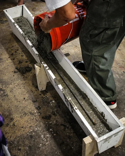 <!--consproject-->

A piece of rebar is placed in the middle of the concrete to make the finished product even stronger. Then more crete goes on top!

