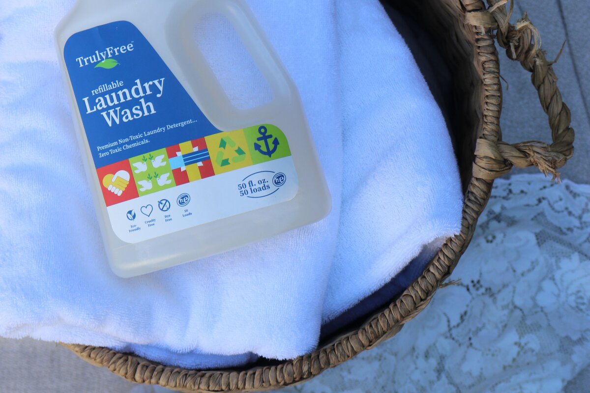 TFH non-toxic laundry wash in a basket on top of towels