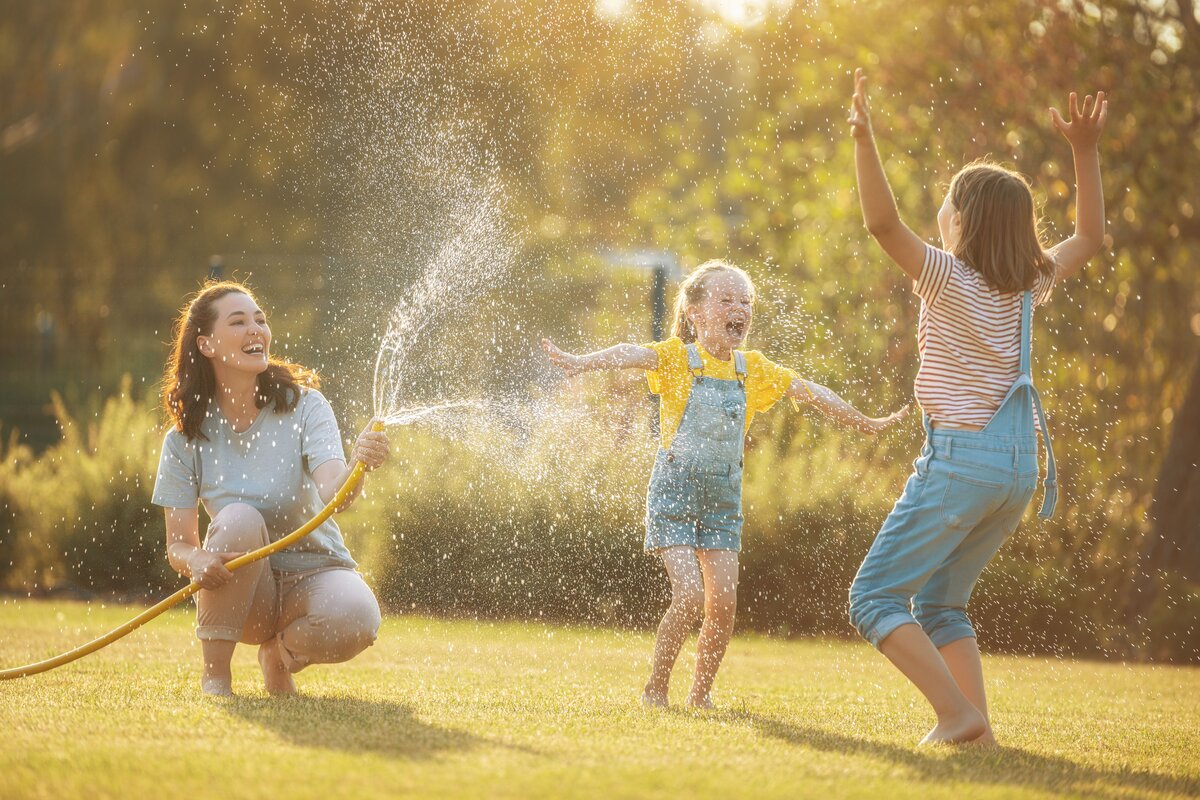Kids playing in sprinklers