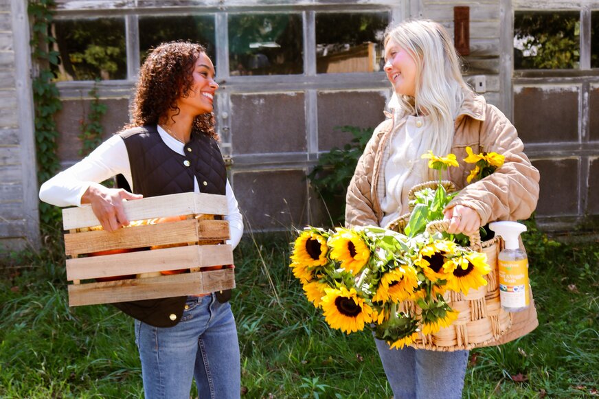 Two girls with baskets full of spring produce.