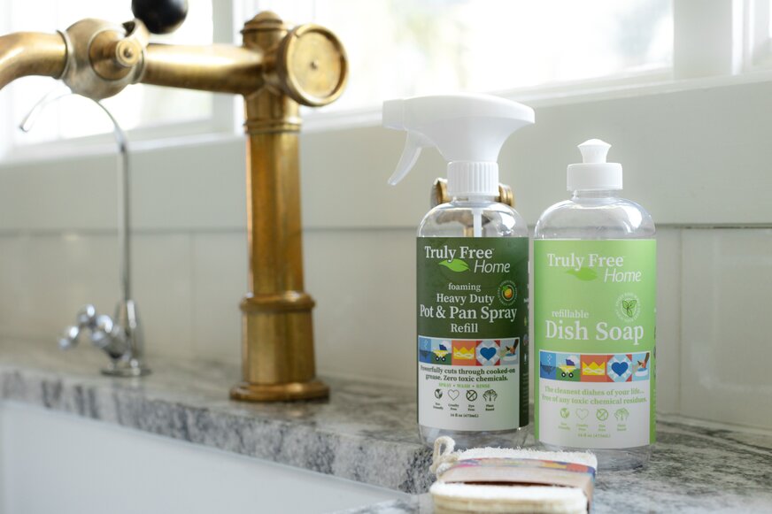 Truly Free Home Dish Soap and Truly Free Home Pot & Pan Spray at the kitchen sink. 