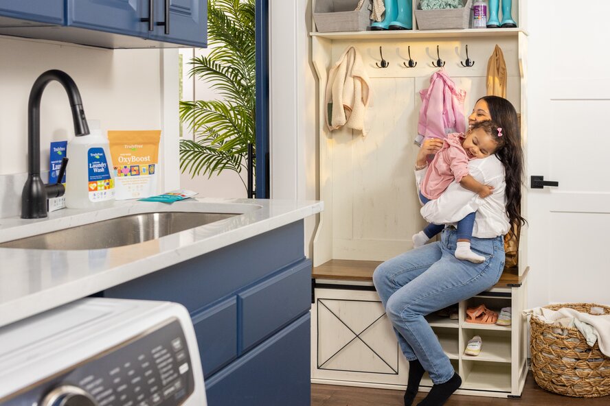 Mom holding toddler daughter. 