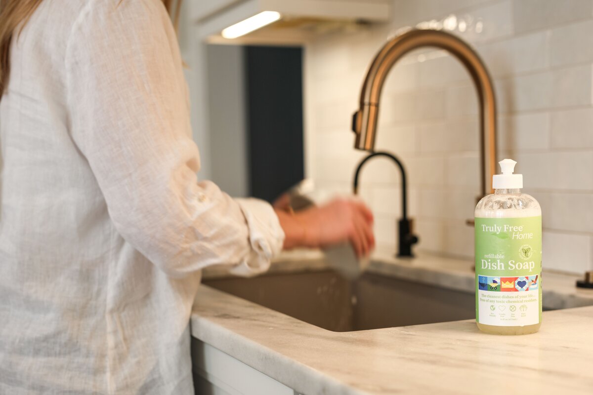 Woman using TFH non-toxic dish soap at the sink