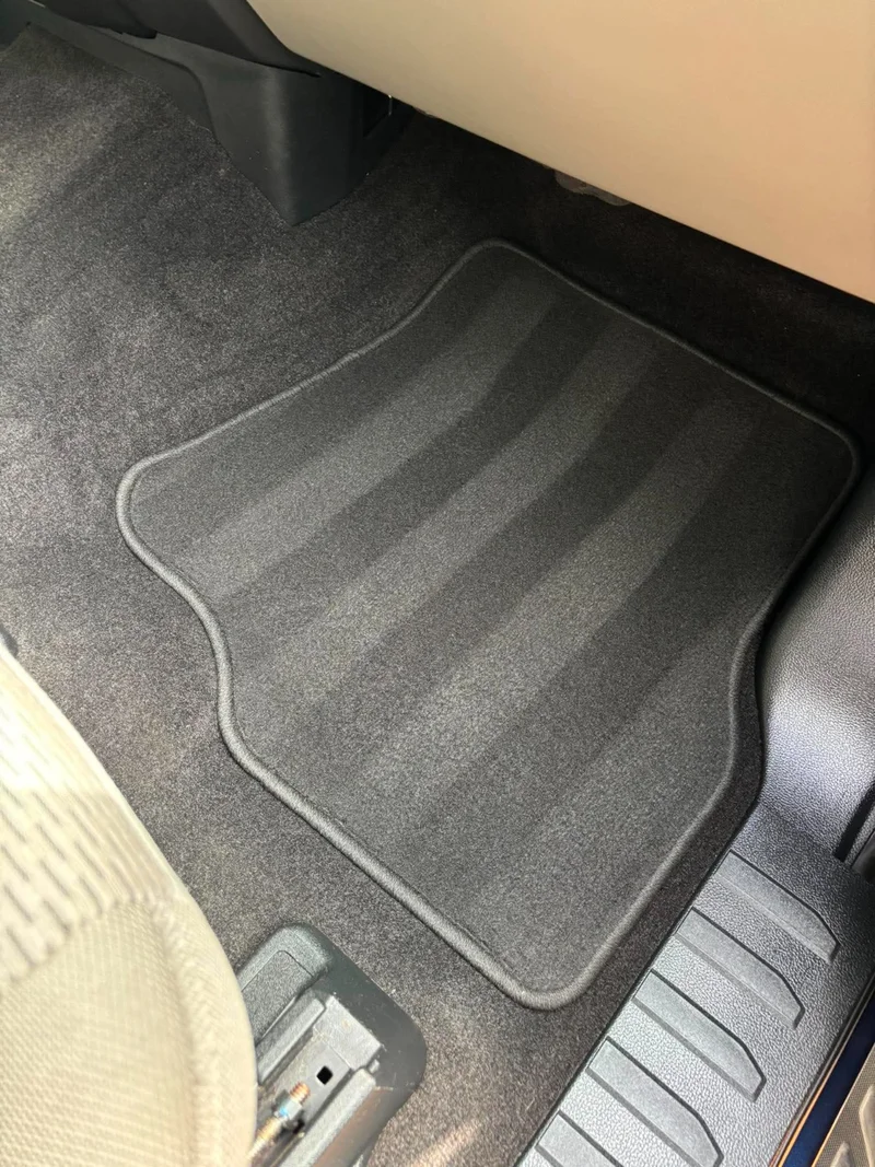 Clean rear passenger cabin with freshly detailed carpet and floor mats