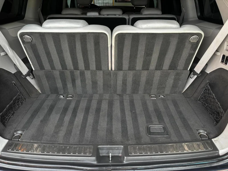 Detailed rear passenger footwell with a clean fitted floor mat