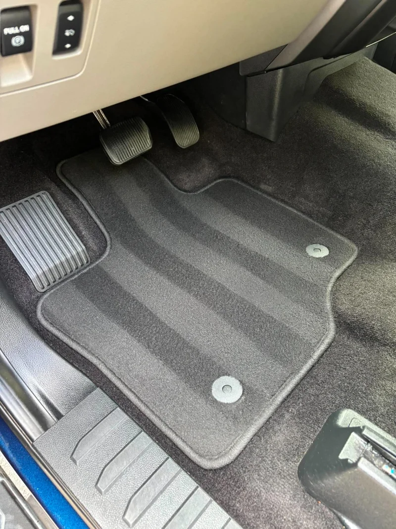 Detailed driver footwell with clean pedals, carpet and floor mat
