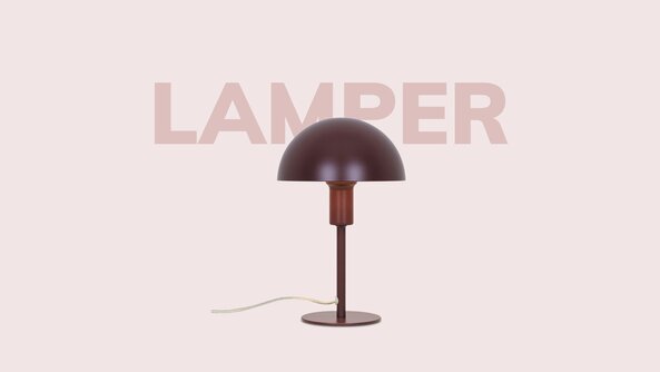 Bordlampe i mørk finish placeret centralt på lys baggrund med teksten “Lamper” i baggrunden.