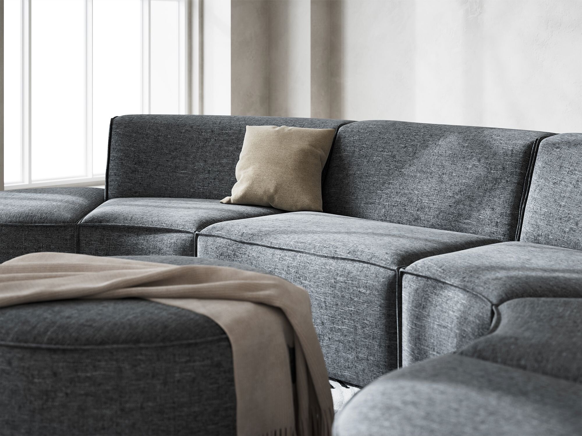 Quadrato modulsofa i mørkegråt møbelstof med lys fra et vindue