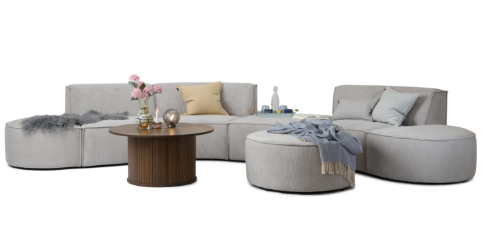 Quadrato modulsofa i gråt stof med runde ender samt en rund puf. 
