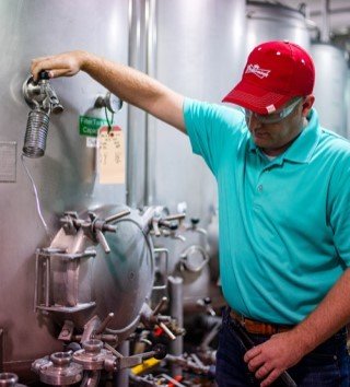 Man working on a beer brewing tank