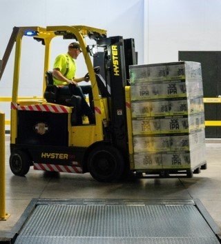 Forklift picking up a crate of packaged beer