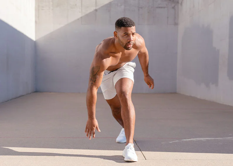Man doing lunges in a concrete room