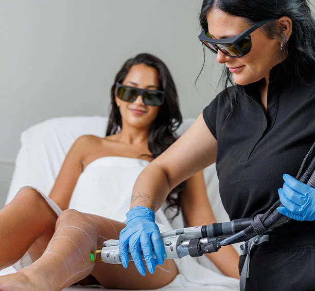 Soman smiling while getting leg laser hair removal
