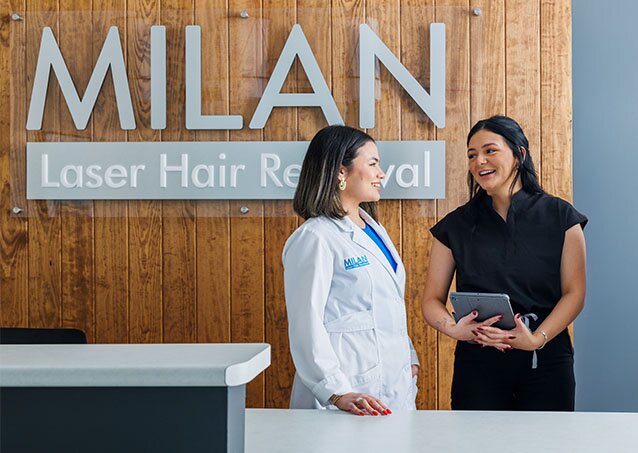 Close-up of a woman going to a Milan Laser Hair Removal clinic and talking to the receptionist