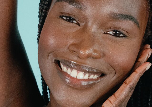 Close-up of a woman's face with nice white teeth for a piece on laser hair removal for hirsutism