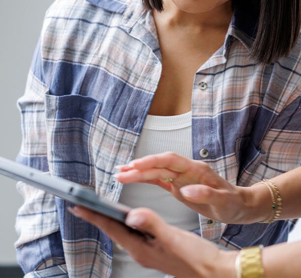 Client in a plaid shirt getting a consultation for laser hair removal treatments for transgender clients