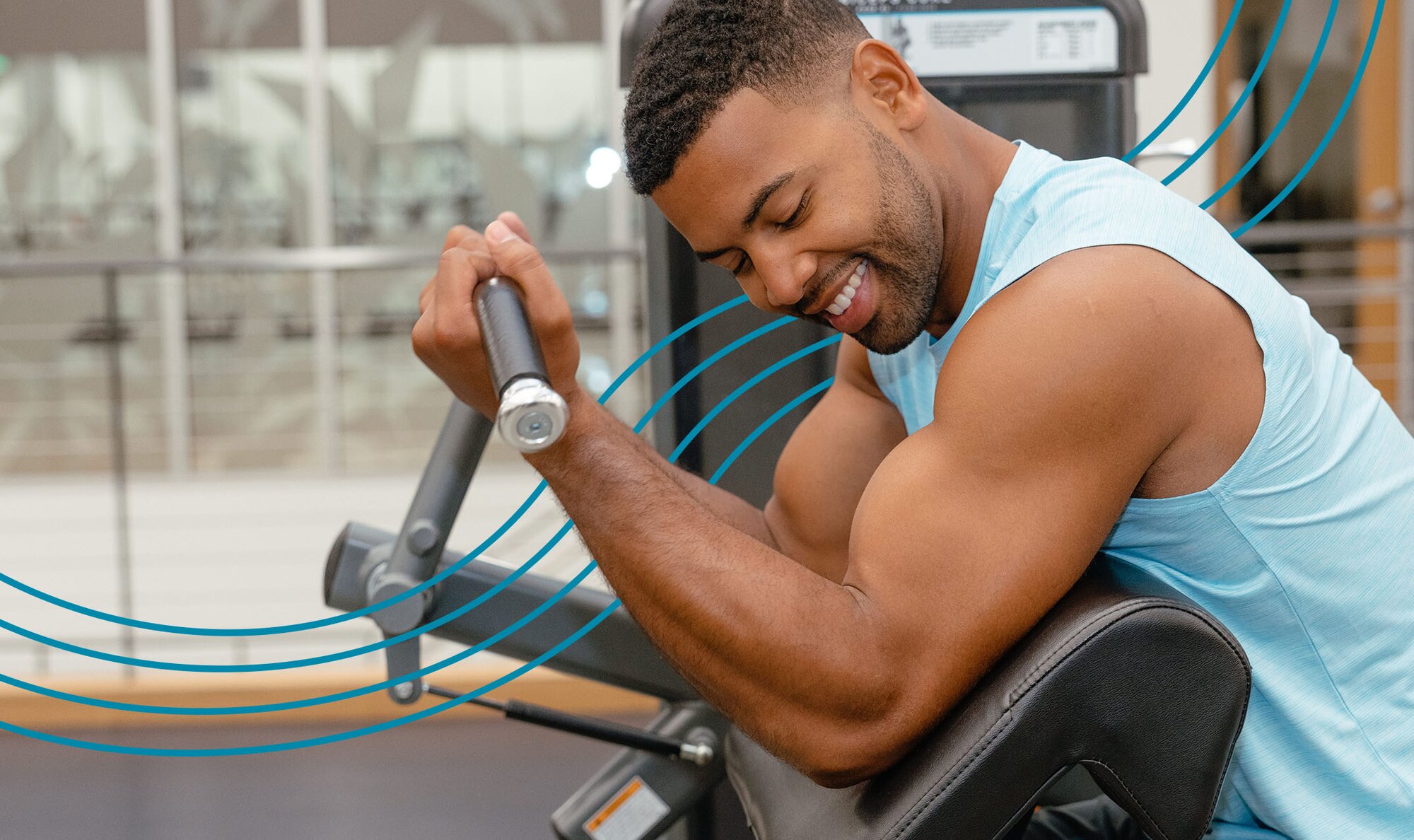 Man in a blue tank top smiling and doing bicep curls. He feels good because he has confidence after getting bodybuilding laser hair removal treatments