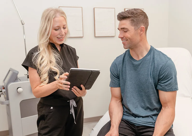 Man who is getting laser hair removal for amputees smiling in a clinic chair at Milan Laser