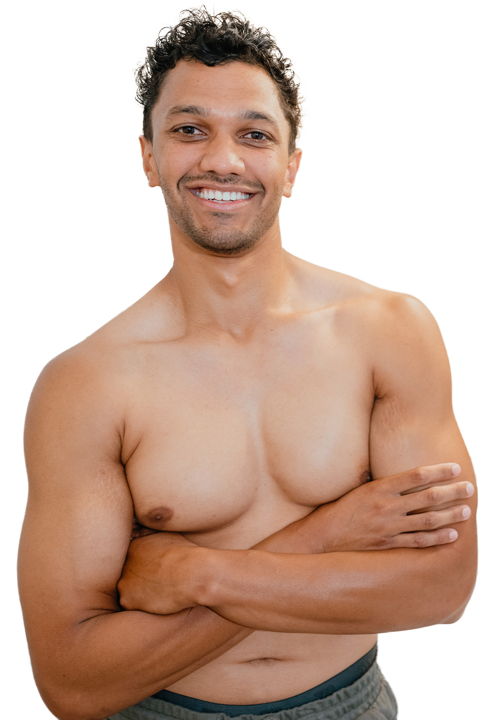 Happy guy shirtless and crossing his arms and brimming with confidence from his newly-completed laser hair removal for men