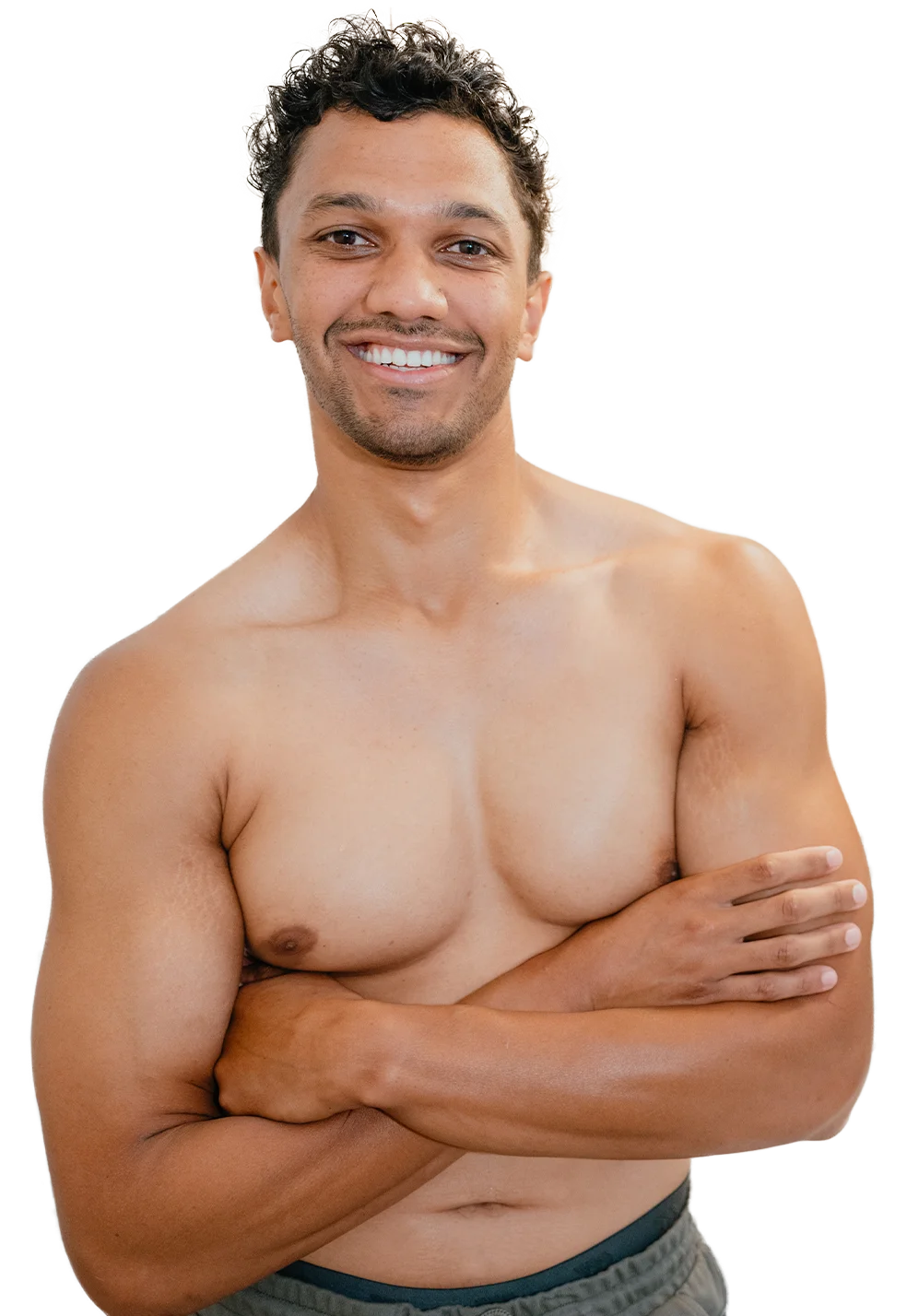 Happy guy shirtless and crossing his arms and brimming with confidence from his newly-completed laser hair removal for men