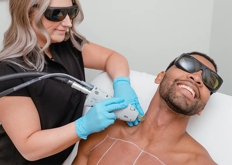 Milan Laser medical professional performing laser hair removal on a male client