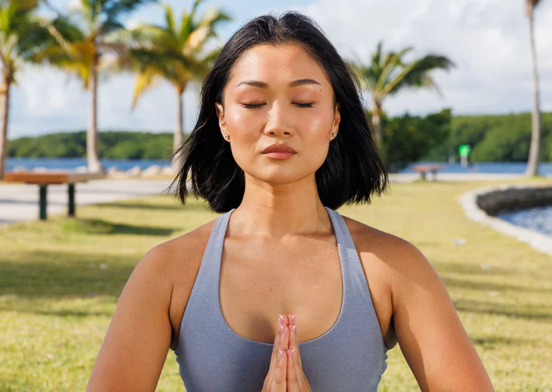 Woman doing yoga outside after getting upper lip laser hair removal
